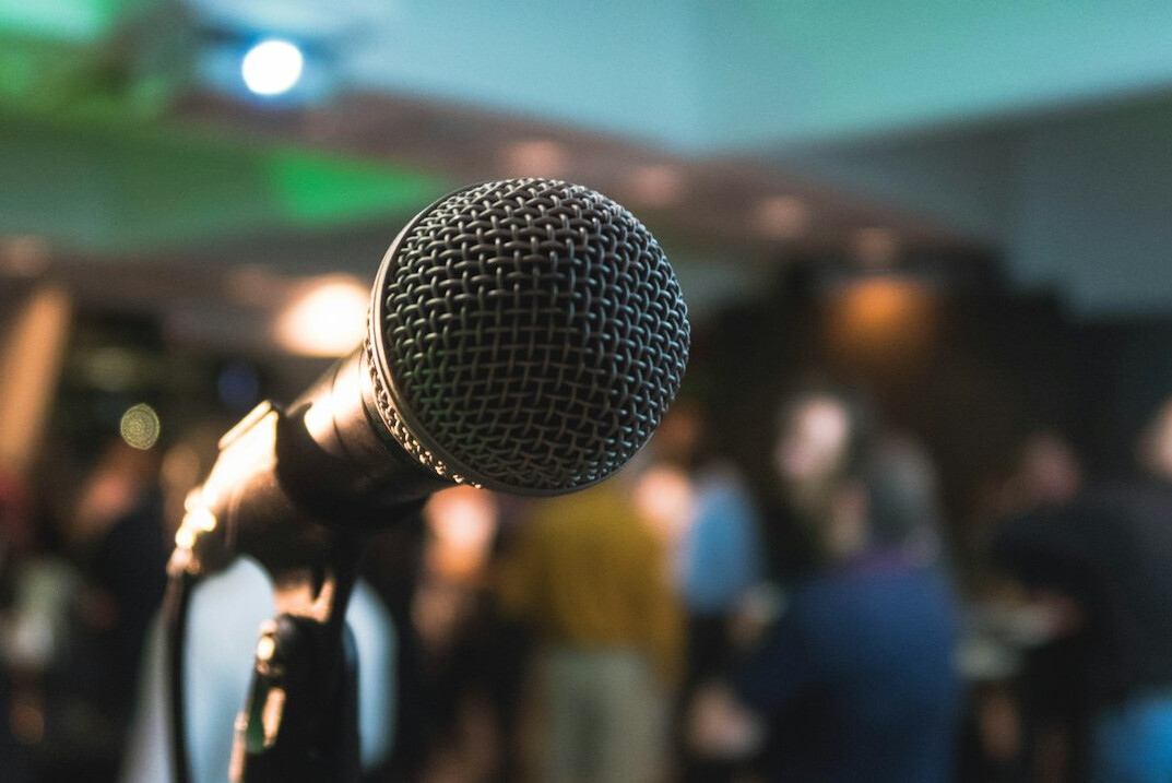 executive on stage with microphone